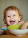 Launching child eat. Smiling baby eating food. Family, food, child, eating and parenthood concept. Royalty Free Stock Photo