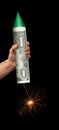 Hand holding dollar bill rocket to launch American economy.