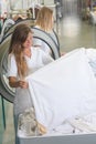 Laundress inspecting white linen Royalty Free Stock Photo