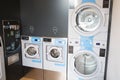 Laundromat dryers row of industrial machines clothes washers Royalty Free Stock Photo