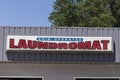 Laundromat sign. Coin operated Laundromats provide a place for travelers to wash their clothes while on the road Royalty Free Stock Photo