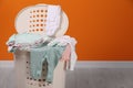 Laundry basket with baby clothes indoors, space for text Royalty Free Stock Photo