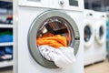 Laundry basket on blurred background of modern washing machine in a contemporary laundry room Royalty Free Stock Photo