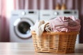 Laundry basket on blurred background of modern washing machine in laundry room interior Royalty Free Stock Photo