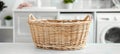 Laundry basket on blurred modern washing machine background with copy space for text placement Royalty Free Stock Photo