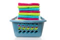 Laundry basket filled with colorful folded towels