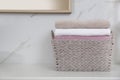 Laundry basket with fresh towels on counter in bathroom Royalty Free Stock Photo