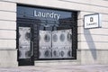Laundry building exterior with washing machines inside it