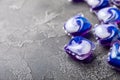 Laundry capsules on a dark textured background. Capsules with liquid washing powder for washing machines. Royalty Free Stock Photo