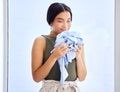 Laundry, cleaning and smell with woman and clothes for fresh, fragrance and aroma from housekeeping. Fabric, cleaner and