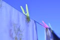 Laundry day clothes on clothesline colorful clothes pins against blue sky Royalty Free Stock Photo