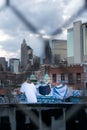 Laundry day in New York City, clothes drying on a Manhattan rooftop among graffiti and skyscrapers