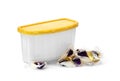 3in1 laundry detergent capsules near a plastic container for capsules on a white background