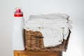 Laundry Detergent and Folded White Linen in a Basket Royalty Free Stock Photo