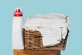 Laundry Detergent and Freshly Folded White Clothes