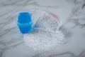 Laundry detergent powder and blue liquid gel in measuring cup Royalty Free Stock Photo