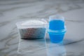 Laundry detergent powder and blue liquid gel in measuring cup Royalty Free Stock Photo