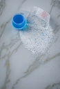 Laundry detergent powder and blue liquid gel in measuring cup Royalty Free Stock Photo