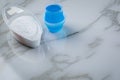 Laundry detergent powder and blue liquid gel in measuring cup Royalty Free Stock Photo