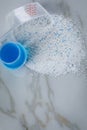 Laundry detergent powder and blue liquid gel in measuring cup Royalty Free Stock Photo