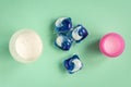 Laundry detergent sorts variety in powder, liquid gel and capsules in washing dose on green Royalty Free Stock Photo