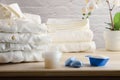 Laundry detergents on wooden table with freshly washed folded clothes Royalty Free Stock Photo