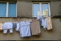 Laundry dries under the windows of a high-rise building