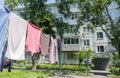 Laundry dries on washing line in courtyard of Khrushchyovka, a common type of old low-cost apartment building in Russia and post-