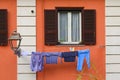 Laundry drying on a line in front of the window in Italy Royalty Free Stock Photo