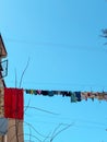 Laundry drying on the street against the background of old residential buildings Royalty Free Stock Photo