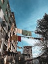 Laundry drying on the street against the background of old residential buildings Royalty Free Stock Photo