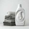 Laundry essentials with stacks of clean clothes and detergent bottle on a simple background for household cleaning Royalty Free Stock Photo