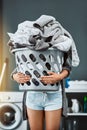 Laundry, hands and woman with basket in her home for housework, washing and hygiene. House, cleaning and female carrying