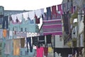 Laundry hanging in front of the windows of the facade in