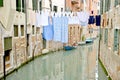 Laundry hanging from the ropes between the buildings on the Venice canal Royalty Free Stock Photo