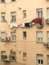 Laundry hanging from a thread in the window of a building in a district of Madrid, Spain Royalty Free Stock Photo