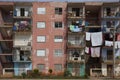 Laundry hangs on clothes lines on balconies of a run down high-rise apartment building Royalty Free Stock Photo