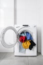 Dirty clothes in open washing machine indoors Royalty Free Stock Photo