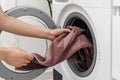 Woman washing laundry using modern automatic machine Royalty Free Stock Photo