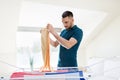 Man taking laundry from drying rack at home