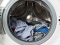 Laundry inside a washing machine drum, showcasing various clothing items Royalty Free Stock Photo