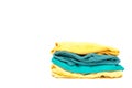 Laundry pile of colorful clothing isolated. stack of trendy color clothes close up with copy space