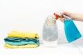 laundry pile of colorful clothing, stack of clothes isolated on white background. woman cleaning dirty rusty iron with