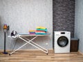 Laundry room interior with washing machine against the wall. Royalty Free Stock Photo