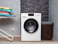 Laundry room interior with washing machine against the wall. Royalty Free Stock Photo