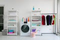 Laundry room interior with washing machine against white wall Royalty Free Stock Photo