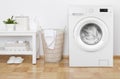 Laundry room interior with washing machine, basket and white shelves Royalty Free Stock Photo