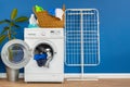 Laundry room interior with washing machine and clothes dryer near wall