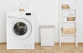 Laundry room interior with washing machine and shelf near wall Royalty Free Stock Photo