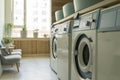 Laundry room interior. Washing machines and dryers in a bright home sunny laundry room.